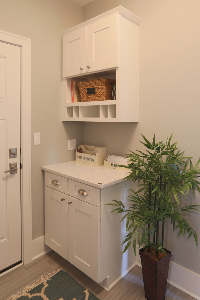 Inspiration for an arts and crafts mudroom in Milwaukee with grey walls and porcelain floors.