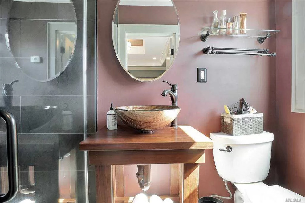 Design ideas for a small modern 3/4 bathroom in New York with glass-front cabinets, light wood cabinets, a two-piece toilet, gray tile, slate, a vessel sink, wood benchtops, a hinged shower door, brown benchtops, a single vanity and a freestanding vanity.
