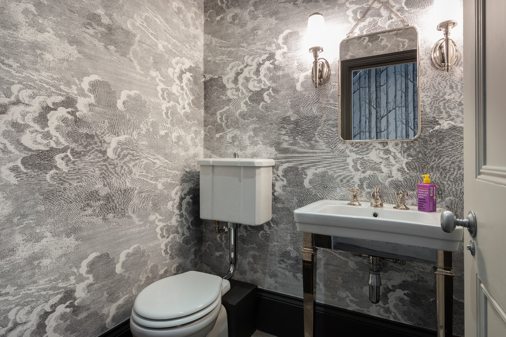Inspiration for a small classic cloakroom in London with a two-piece toilet, multi-coloured walls and a console sink.