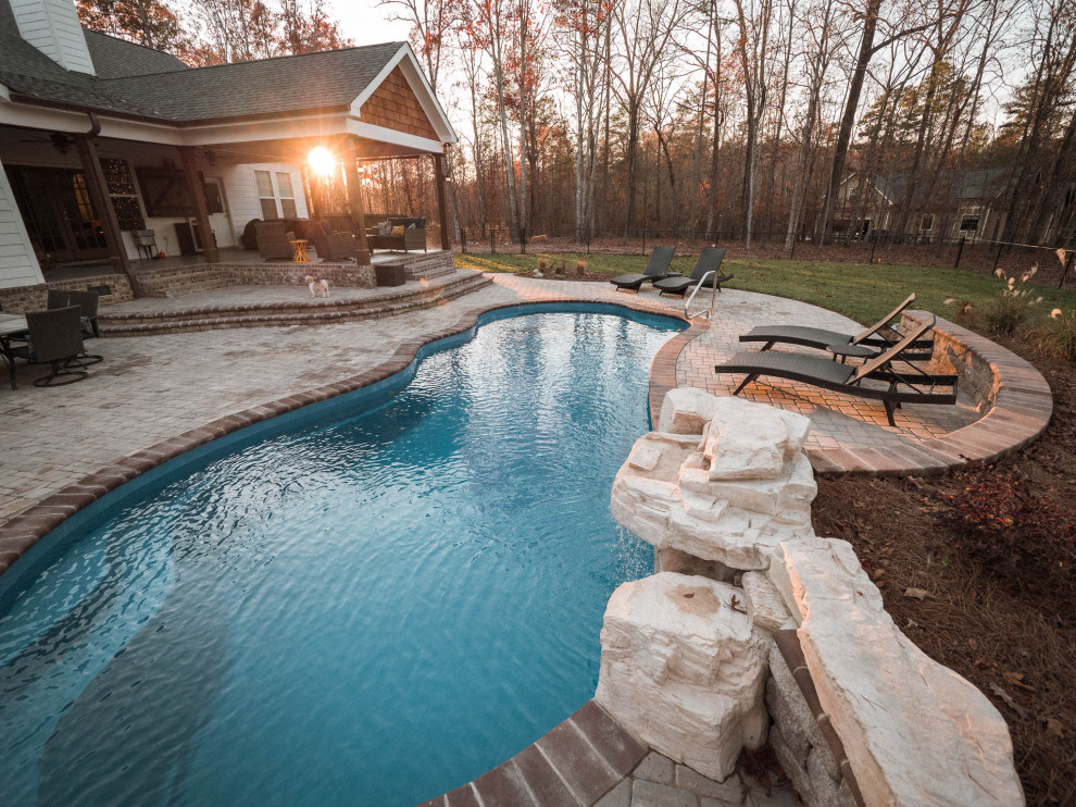 Idee per una piscina country di medie dimensioni e dietro casa con lastre di cemento