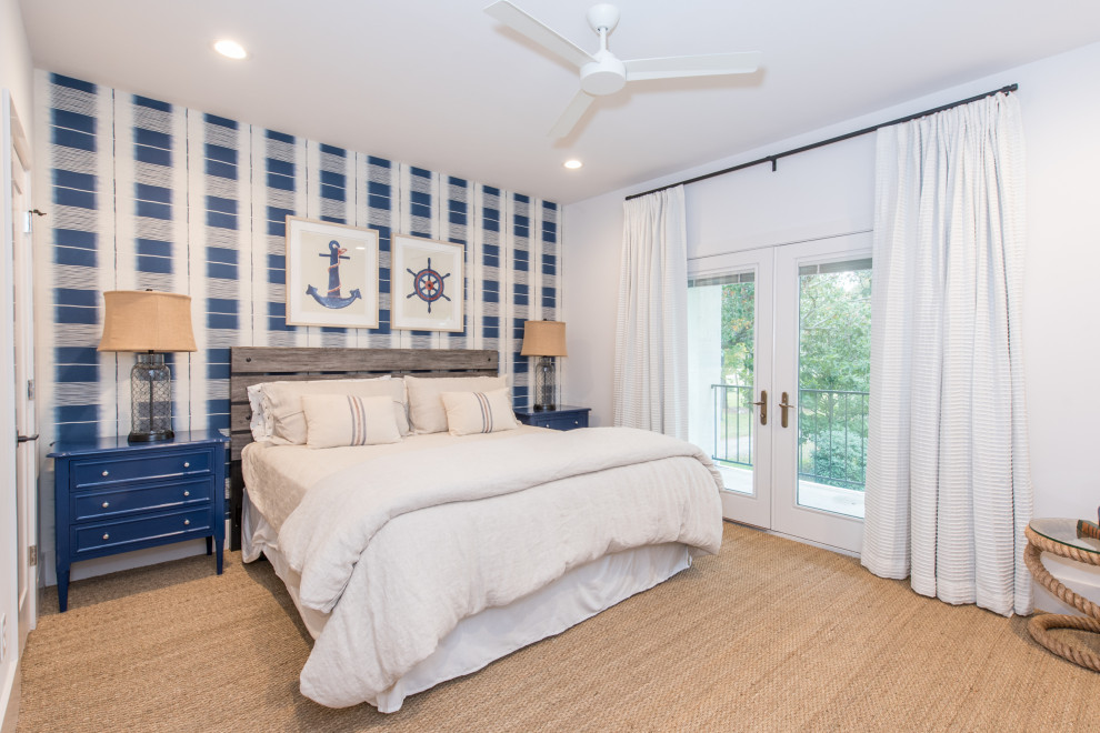 Inspiration for a beach style bedroom in Dallas with blue walls, carpet, brown floor and wallpaper.