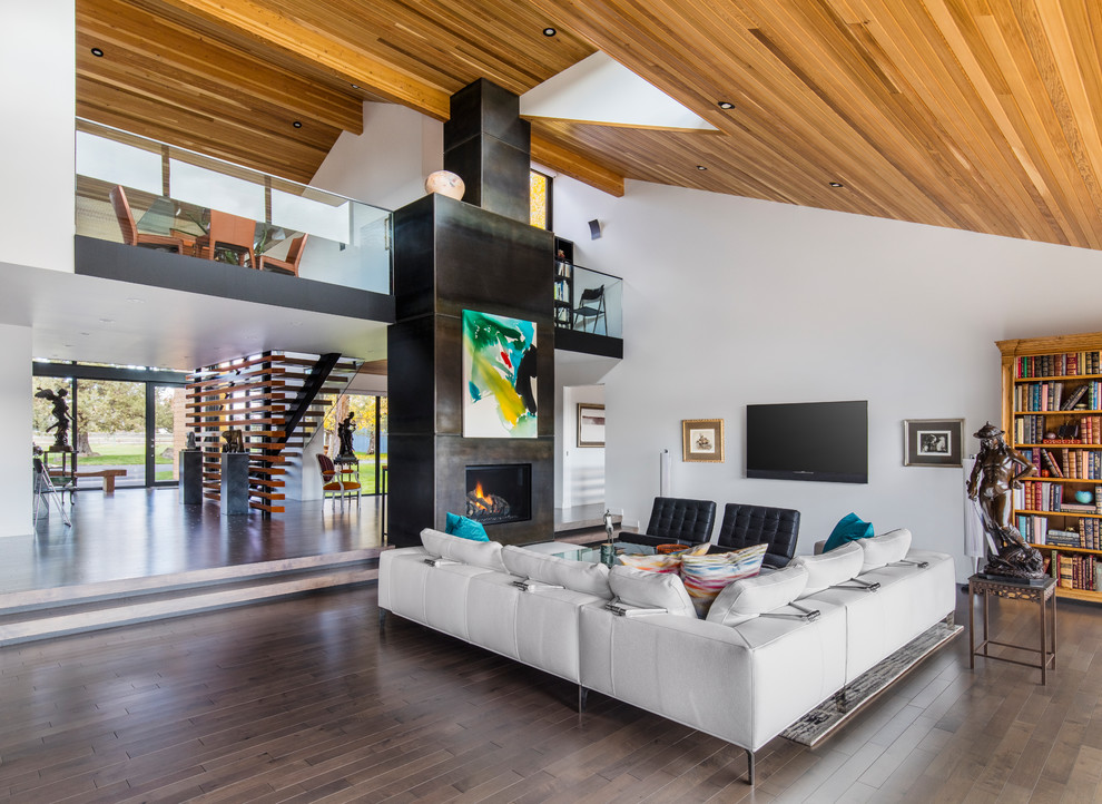 Example of a large trendy open concept brown floor and dark wood floor living room design in Portland with white walls, a metal fireplace, a wall-mounted tv and a standard fireplace