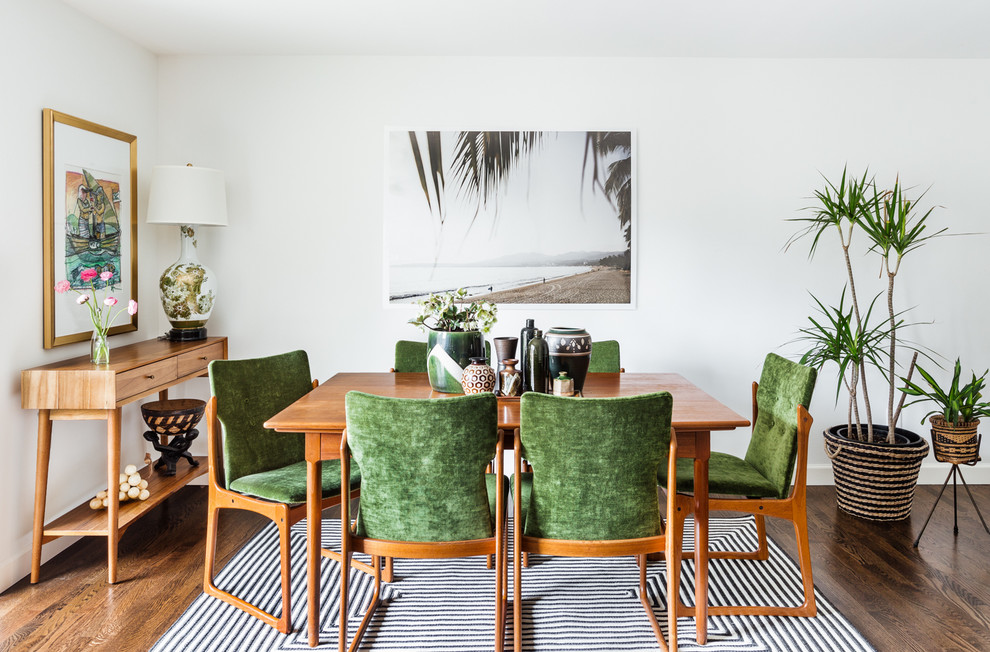 Inspiration for a tropical dining room in Seattle with white walls and medium hardwood floors.