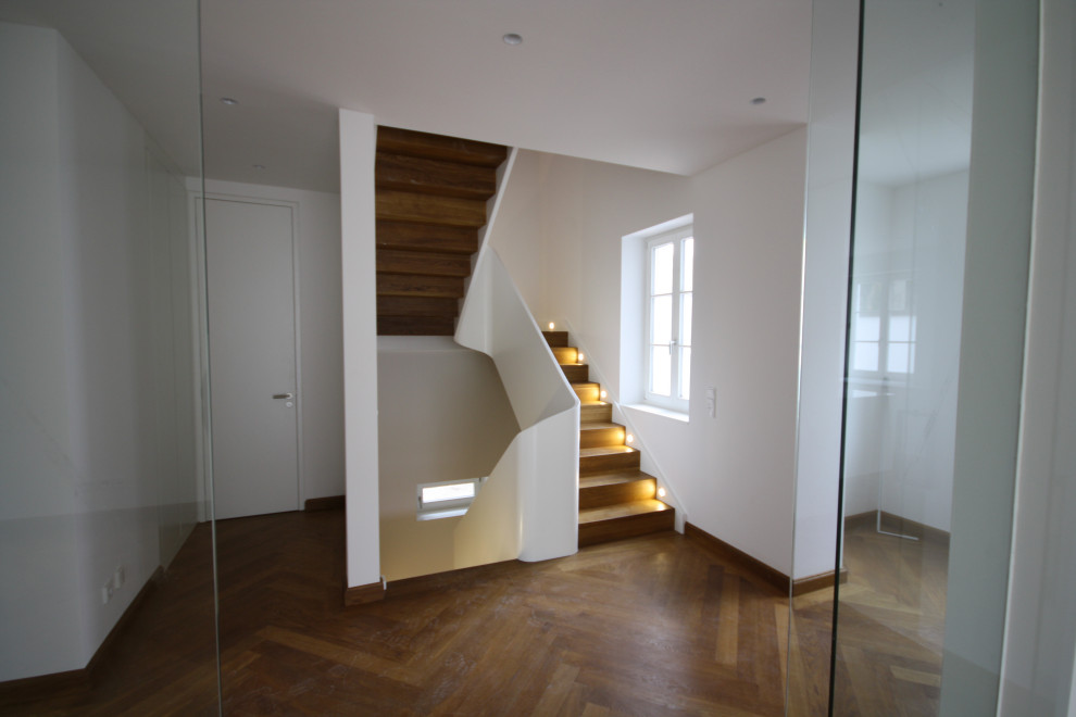Aménagement d'un escalier contemporain avec des marches en bois et des contremarches en bois.