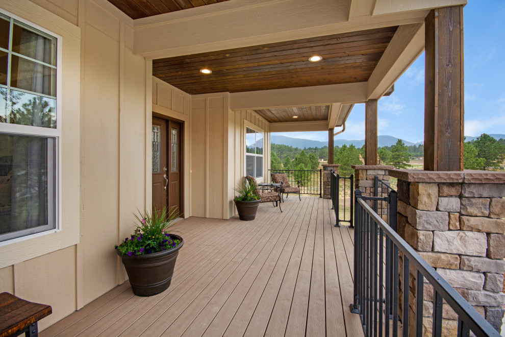 Mid-sized arts and crafts front yard verandah in Denver with decking and a roof extension.