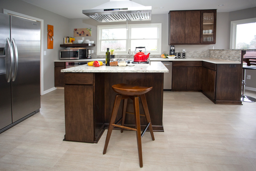 Photo of a large midcentury u-shaped kitchen in Portland with an undermount sink, quartz benchtops, matchstick tile splashback, stainless steel appliances, porcelain floors, with island, beige floor, flat-panel cabinets, dark wood cabinets, grey splashback and white benchtop.