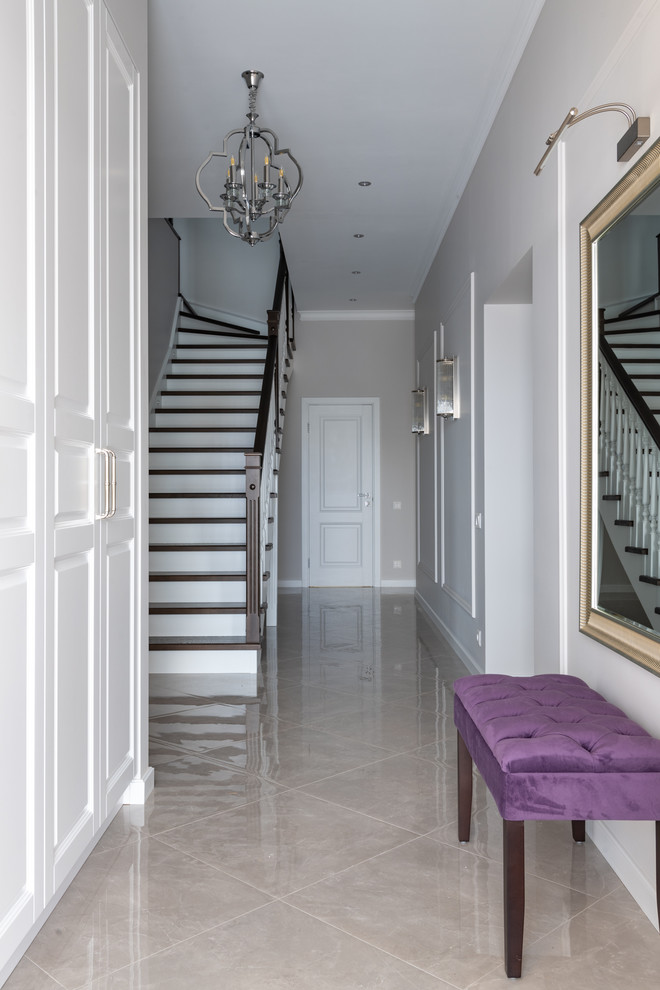 This is an example of a large transitional entry hall in Moscow with grey walls, porcelain floors, a single front door, a white front door and grey floor.