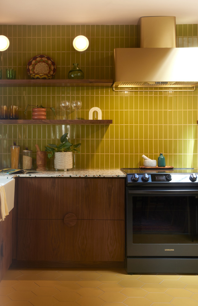 Photo of a mid-sized modern l-shaped kitchen in Atlanta with green splashback, ceramic splashback, ceramic floors and yellow floor.