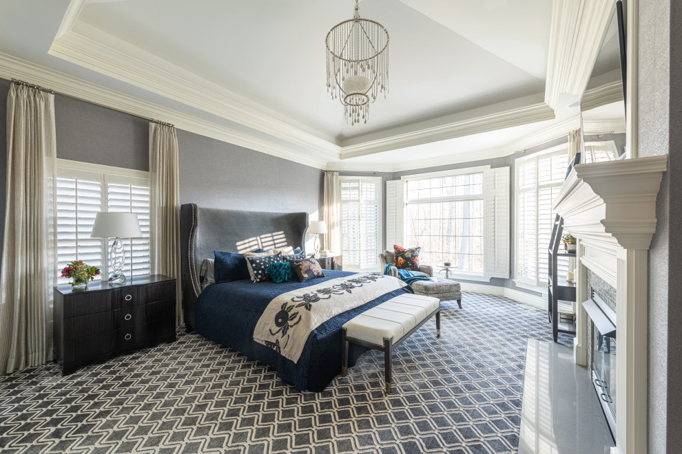 На фото: хозяйская спальня среднего размера в стиле неоклассика (современная классика) с серыми стенами, ковровым покрытием, фасадом камина из плитки, серым полом, деревянным потолком и обоями на стенах без камина