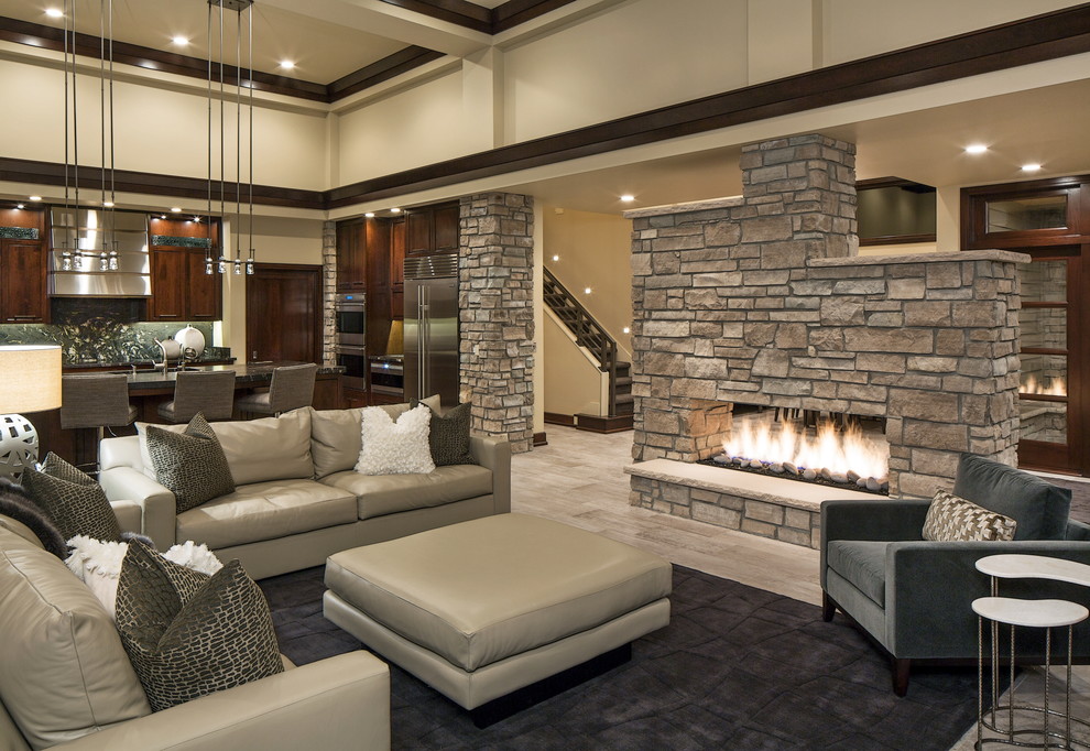 Inspiration for a country living room in Omaha with beige walls, light hardwood floors, a two-sided fireplace and no tv.