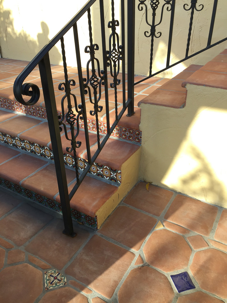This is an example of a medium sized tiled straight staircase in Los Angeles with tiled risers.
