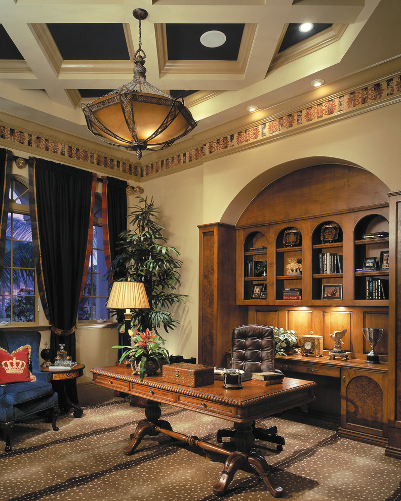 This is an example of a large mediterranean study room in Miami with beige walls, carpet, no fireplace and a freestanding desk.