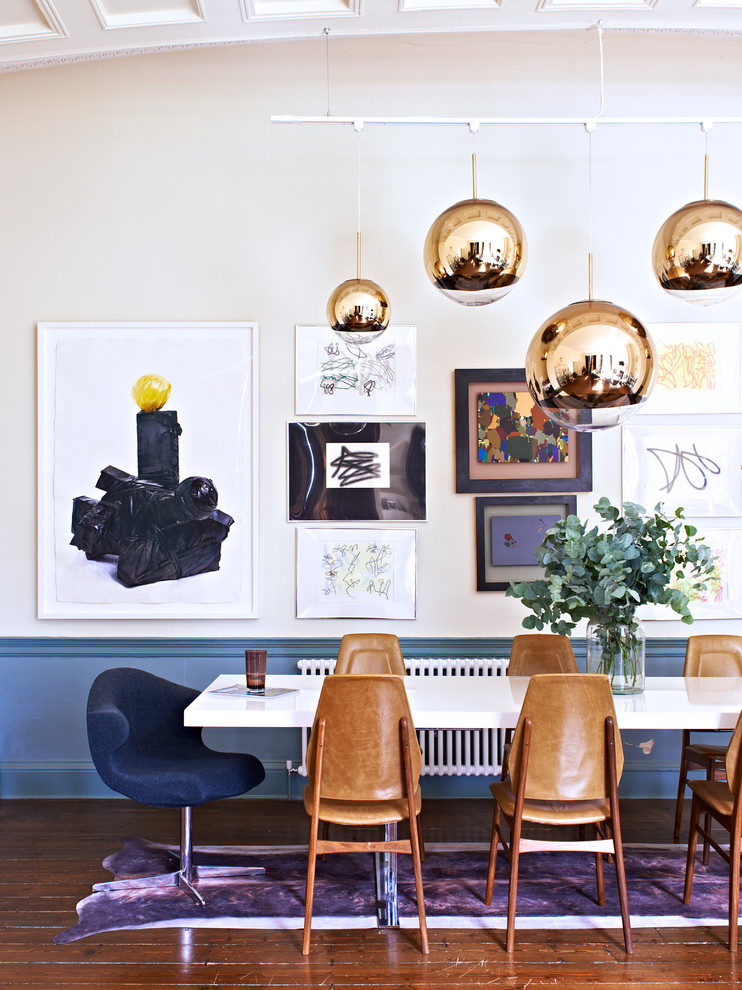 Photo of a medium sized midcentury open plan dining room in London with dark hardwood flooring, brown floors, blue walls and a dado rail.