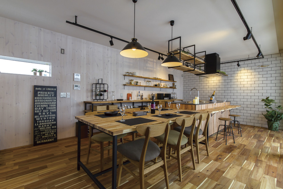 Photo of an industrial open plan kitchen in Other with painted wood floors and brown floor.