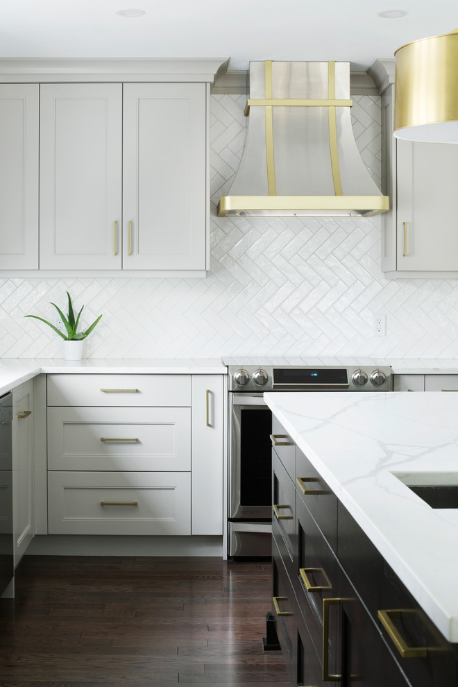 Kitchen - transitional l-shaped kitchen idea in Calgary with shaker cabinets, gray cabinets, quartz countertops, white backsplash, porcelain backsplash, stainless steel appliances and an island
