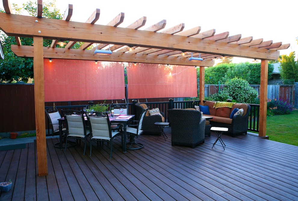 Design ideas for a mid-sized contemporary backyard deck in Other with a roof extension.