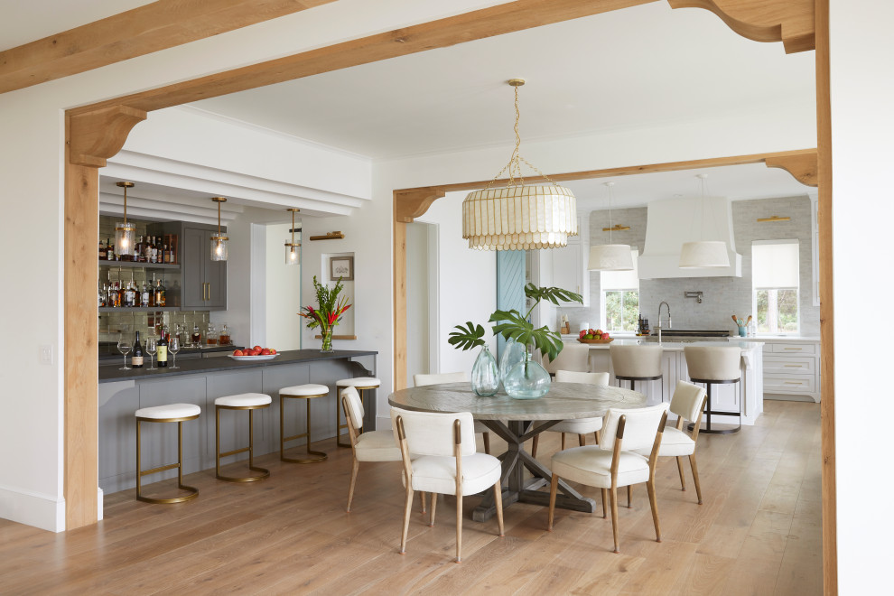 Mid-sized beach style light wood floor kitchen/dining room combo photo in Denver with white walls and no fireplace