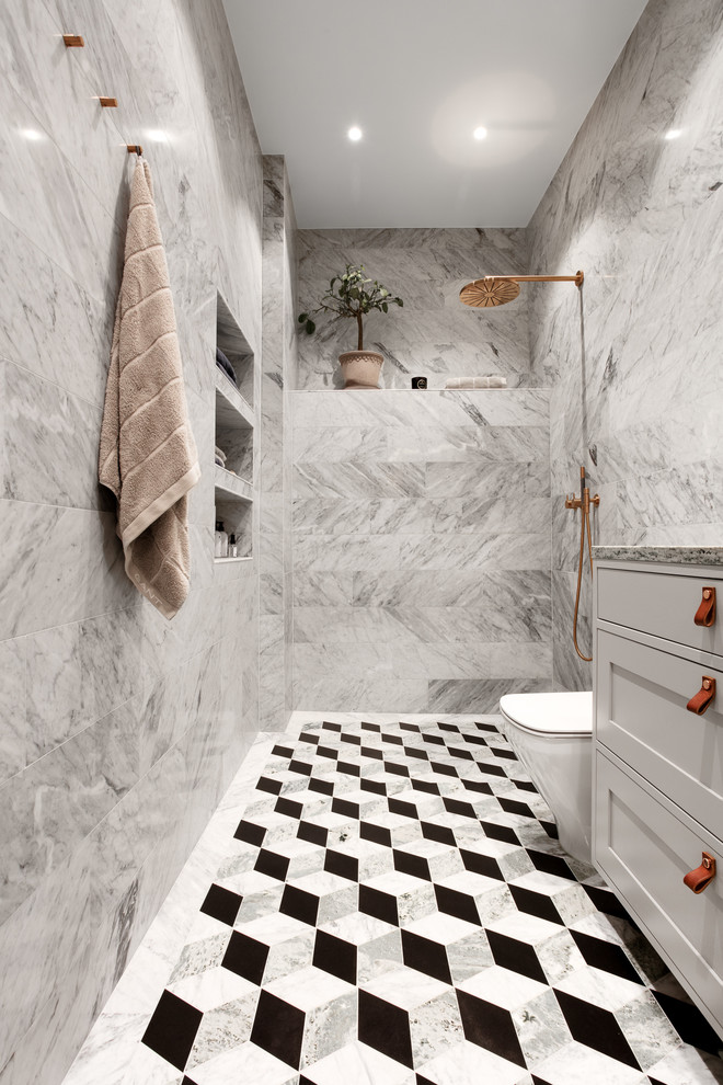 Photo of a mid-sized scandinavian bathroom in Stockholm with recessed-panel cabinets, grey cabinets, an open shower, gray tile and multi-coloured floor.