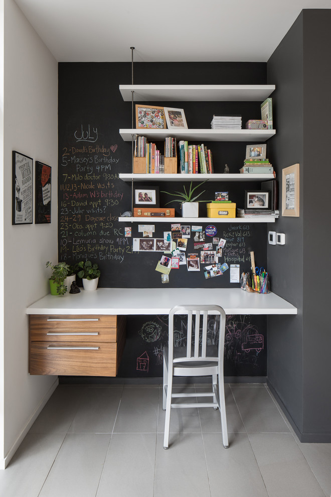 Contemporary study room in Ottawa with black walls, no fireplace, a built-in desk and grey floor.