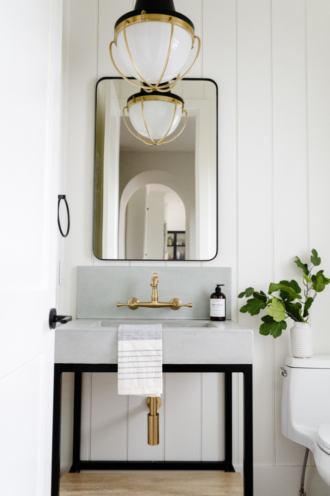 Example of a transitional single-sink and shiplap wall toilet room design with gray cabinets, a one-piece toilet, white walls, a drop-in sink, gray countertops and a freestanding vanity