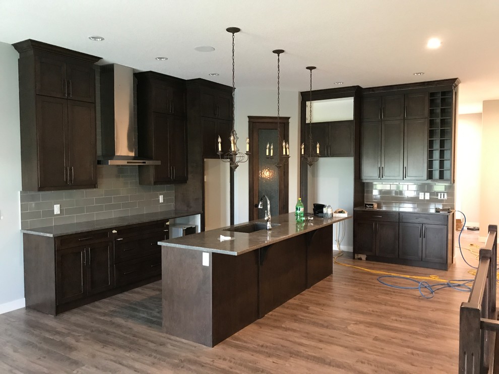Example of a transitional kitchen design in Calgary
