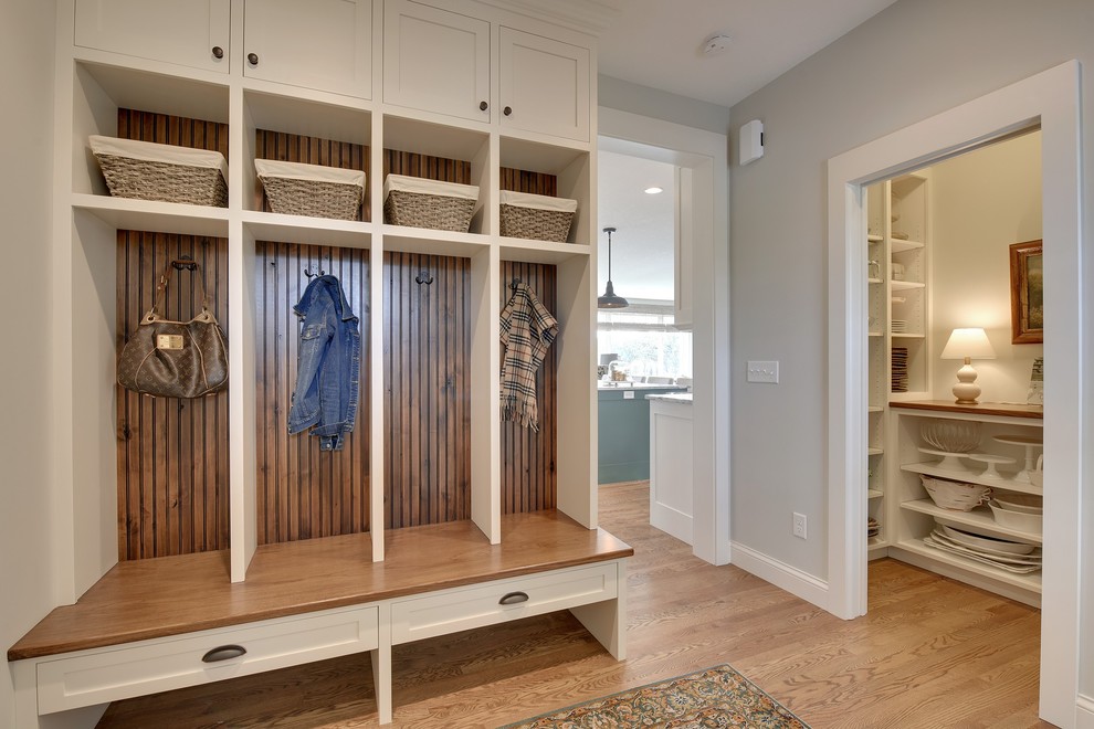 Country mudroom in Minneapolis with grey walls and medium hardwood floors.