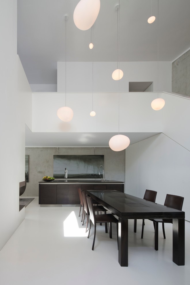 This is an example of a large contemporary open plan dining in Berlin with white walls and vinyl floors.