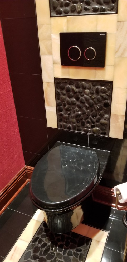 Mid-sized asian bathroom in Cleveland with a wall-mount toilet, pebble tile floors, a vessel sink, granite benchtops and black floor.
