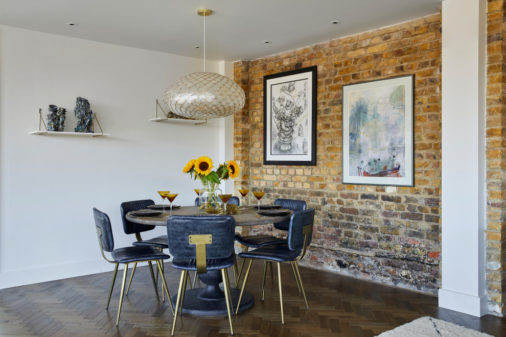 Contemporary dining room in London with red walls, dark hardwood floors, brown floor and brick walls.