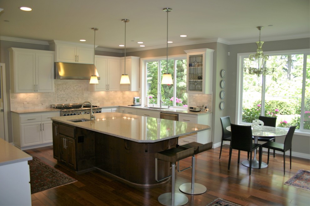 Large transitional u-shaped dark wood floor and brown floor eat-in kitchen photo in Austin with an undermount sink, raised-panel cabinets, white cabinets, granite countertops, stainless steel appliances, an island, white backsplash and marble backsplash