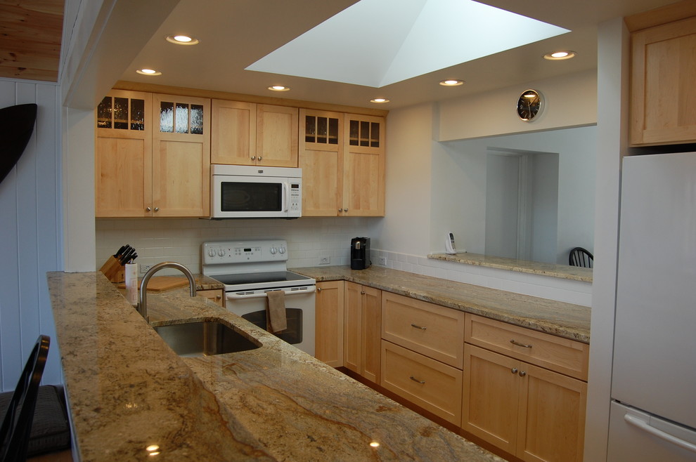 Enclosed kitchen - mid-sized craftsman galley medium tone wood floor enclosed kitchen idea in Burlington with an undermount sink, shaker cabinets, light wood cabinets, granite countertops, white backsplash, ceramic backsplash, white appliances, white walls and no island