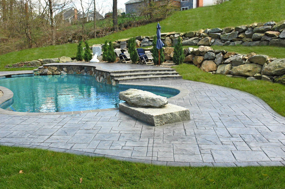 Photo of a mid-sized backyard patio in Bridgeport with stamped concrete.