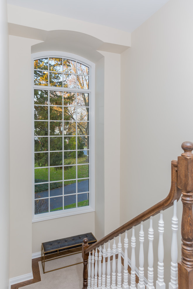 Staircase - large transitional carpeted u-shaped wood railing staircase idea in Chicago with carpeted risers