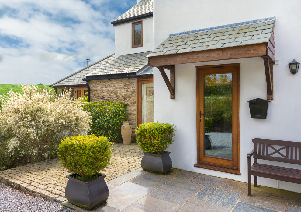 Design ideas for a country front door in Devon with white walls, a single front door and a glass front door.