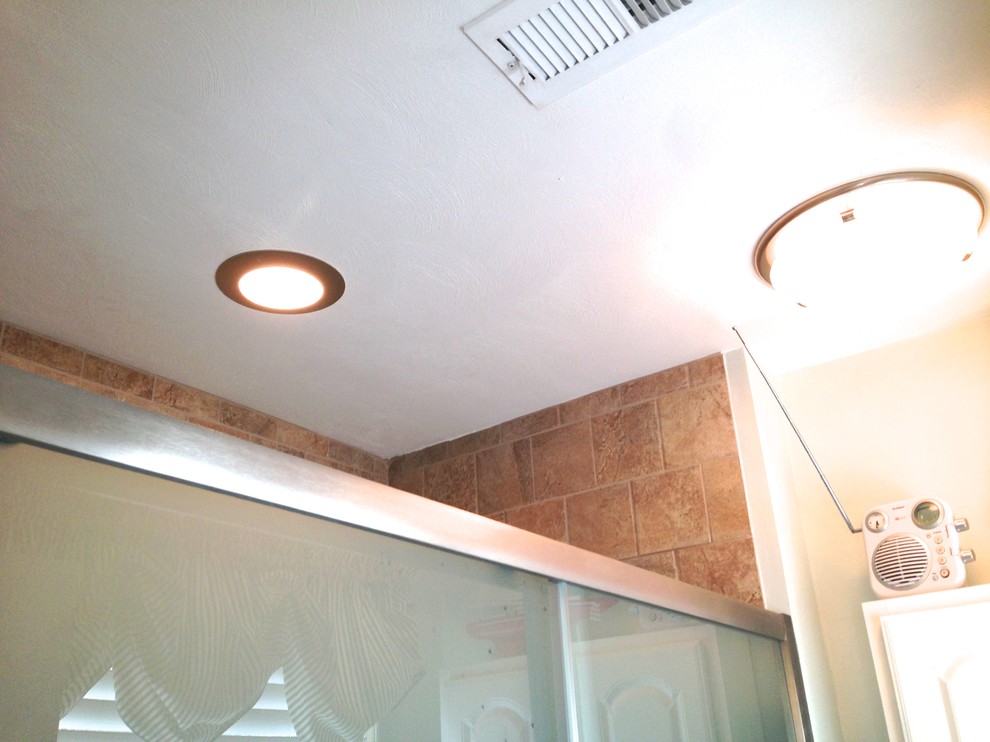 Inspiration for a mid-sized transitional master beige tile and porcelain tile porcelain tile alcove shower remodel with raised-panel cabinets, white cabinets, a two-piece toilet and blue walls