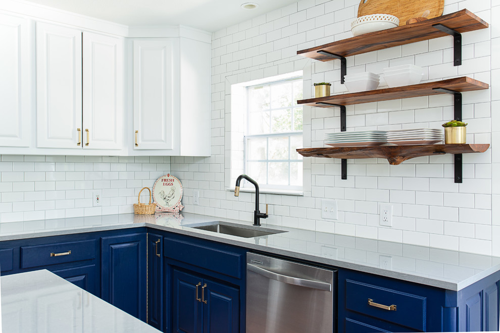 Inspiration for a mid-sized country u-shaped eat-in kitchen in Dallas with an undermount sink, raised-panel cabinets, blue cabinets, quartz benchtops, white splashback, ceramic splashback, stainless steel appliances, with island and grey benchtop.