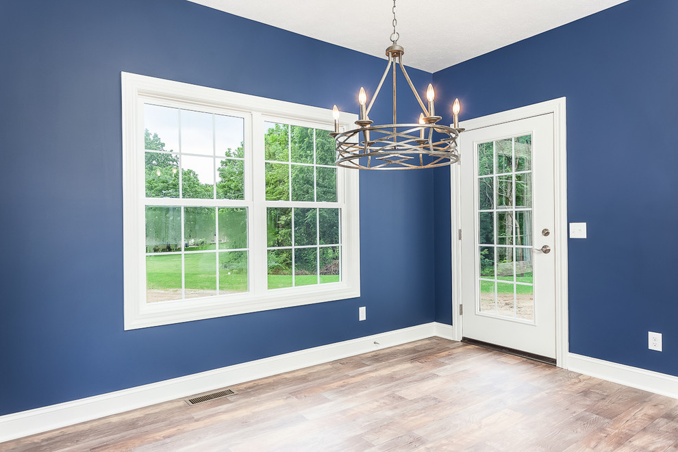 Inspiration for a mid-sized transitional separate dining room in Cleveland with blue walls, medium hardwood floors, no fireplace and brown floor.