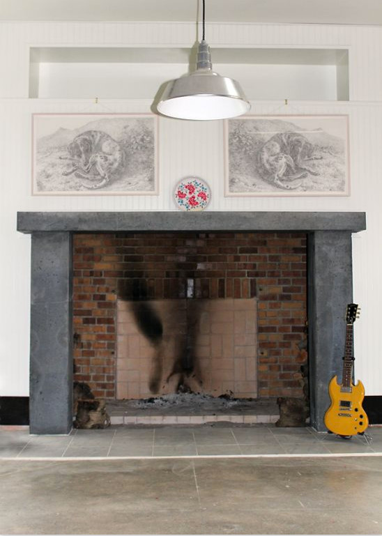Inspiration for a mid-sized industrial open concept family room in Seattle with a music area, white walls, concrete floors, a standard fireplace, a brick fireplace surround, no tv and grey floor.