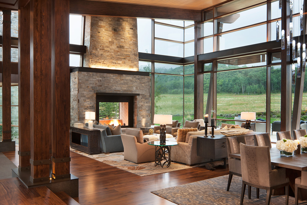 Inspiration for an expansive country living room in Denver with a two-sided fireplace and a stone fireplace surround.