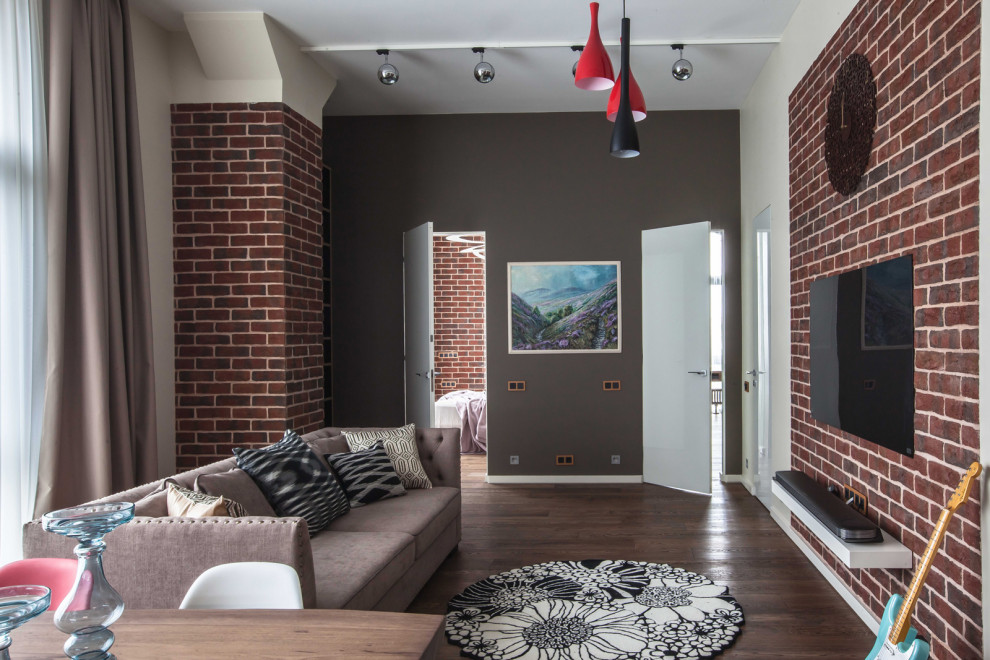 This is an example of a mid-sized industrial living room in Moscow with a music area, brown walls, dark hardwood floors, no fireplace, a wall-mounted tv, brown floor and brick walls.