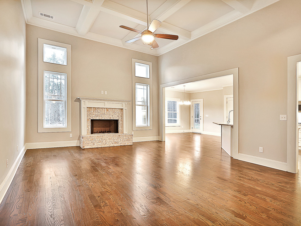 Photo of a traditional living room in Atlanta with a standard fireplace and a brick fireplace surround.