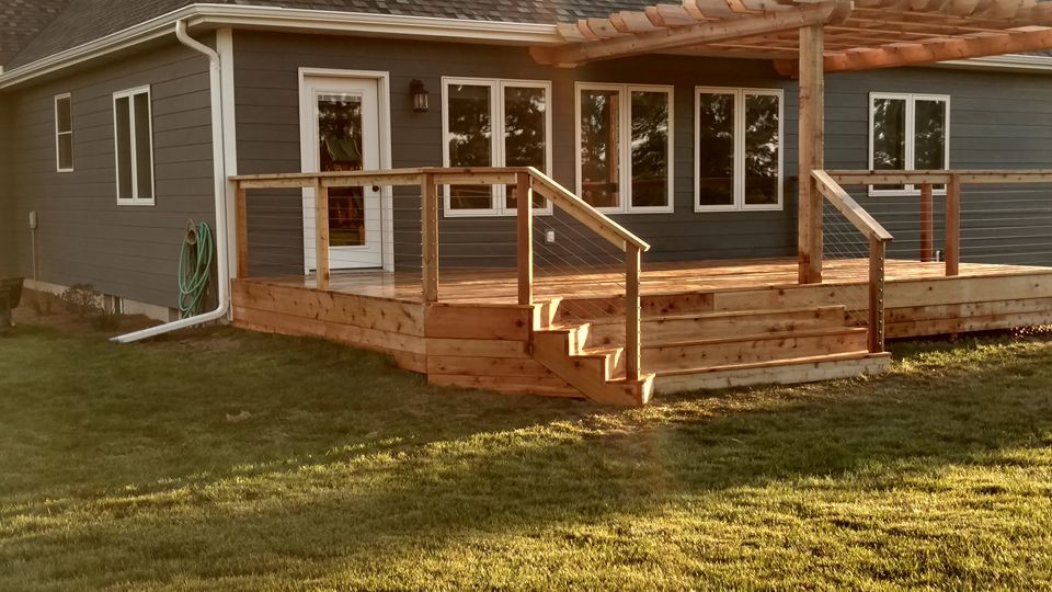Deck - large rustic deck idea with a pergola