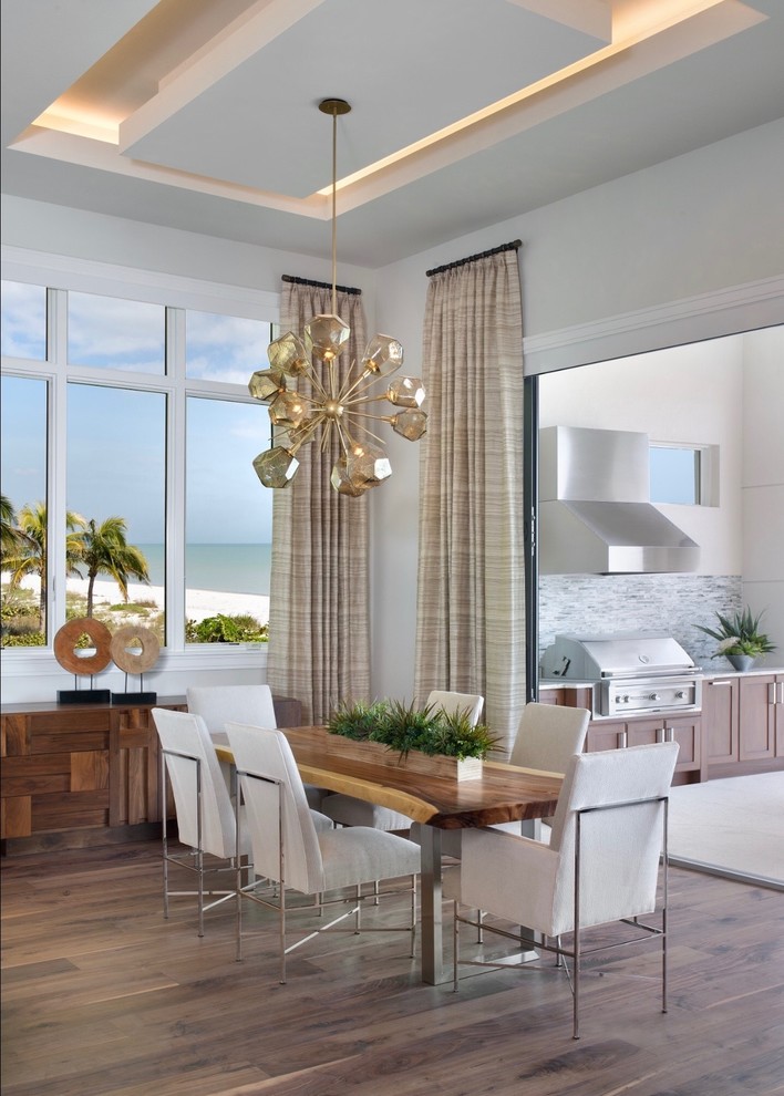 This is an example of a mid-sized contemporary separate dining room in Miami with grey walls, medium hardwood floors, no fireplace and brown floor.