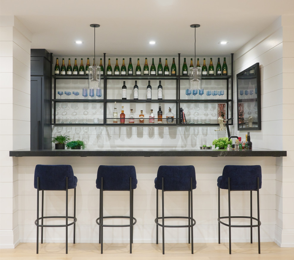 Design ideas for a transitional galley seated home bar in Other with light hardwood floors, beige floor and black benchtop.