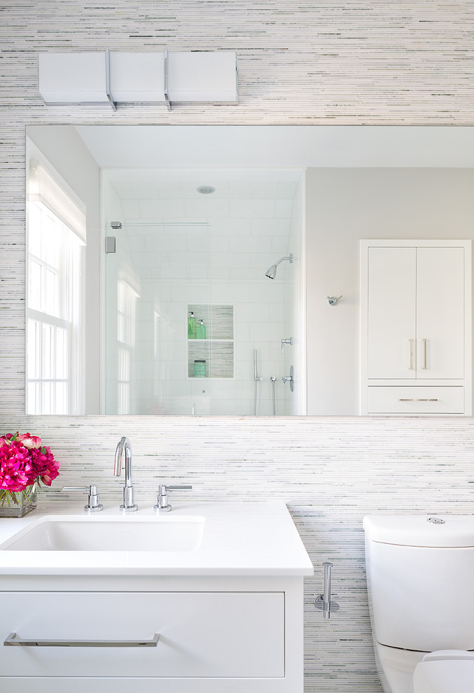 Example of a trendy bathroom design in New York with flat-panel cabinets, white cabinets, an undermount sink and white walls
