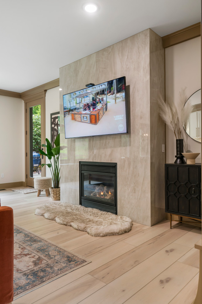 Large classic formal open plan living room in Seattle with white walls, vinyl flooring, a standard fireplace, a metal fireplace surround, a wall mounted tv and beige floors.