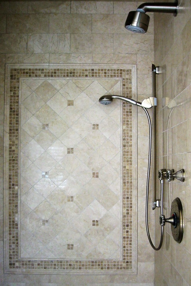 Design ideas for a large traditional master bathroom in Boston with recessed-panel cabinets, beige cabinets, a drop-in tub, a double shower, a one-piece toilet, beige tile, limestone, beige walls, limestone floors, an undermount sink, marble benchtops, beige floor and a hinged shower door.
