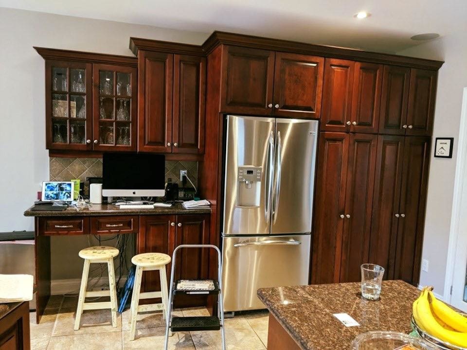 Example of a transitional kitchen design in Toronto with quartzite countertops and an island