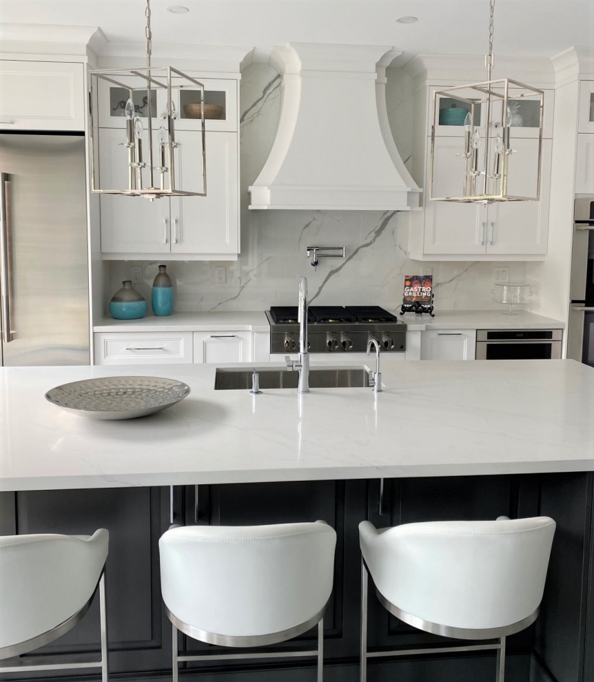 Open concept kitchen - large transitional l-shaped porcelain tile and white floor open concept kitchen idea in Toronto with an undermount sink, recessed-panel cabinets, white cabinets, quartz countertops, white backsplash, stone slab backsplash, stainless steel appliances, an island and white countertops