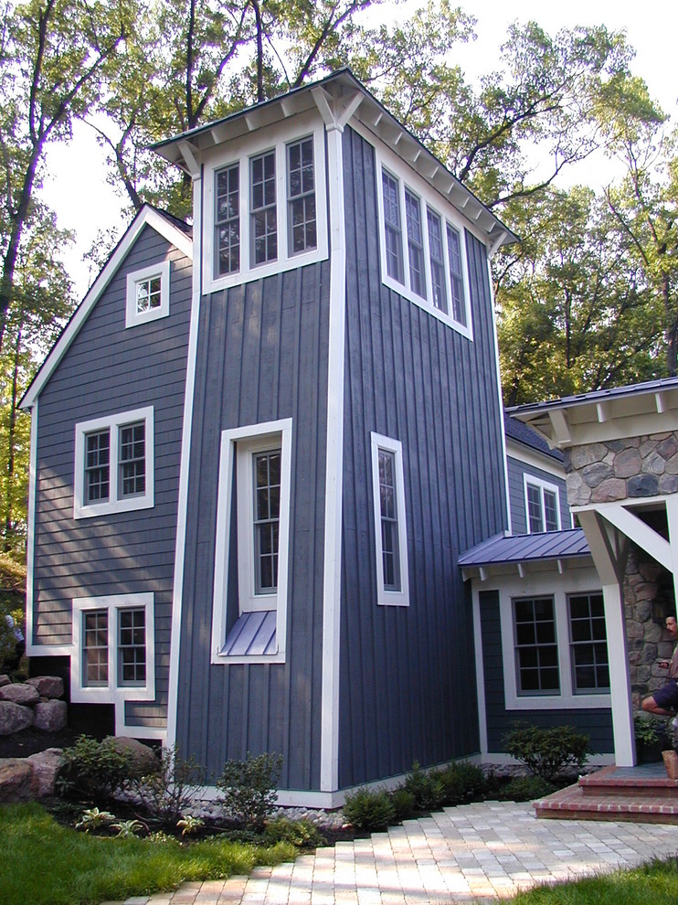 Inspiration for a large transitional three-storey blue exterior in Detroit with wood siding and a gable roof.